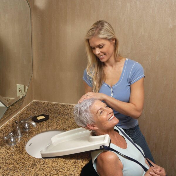 a woman giving a hair spa to an elderly woman